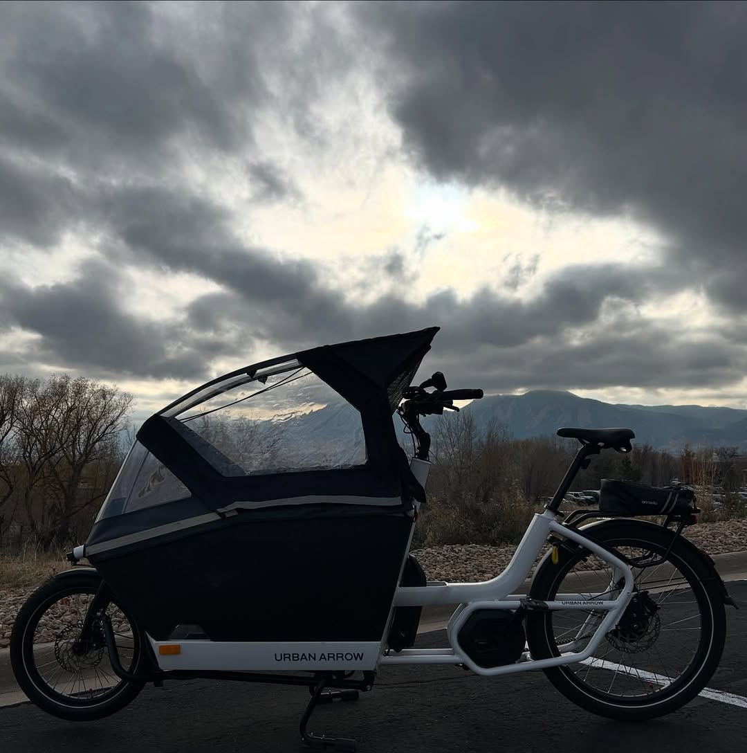 An Urban Arrow cargo bike under a cloudy sky