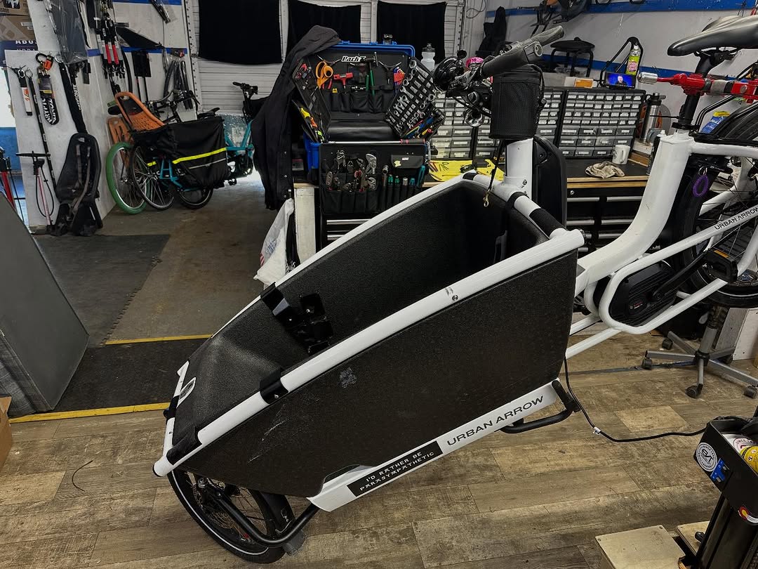 An Urban Arrow cargo bike being worked on in the shop