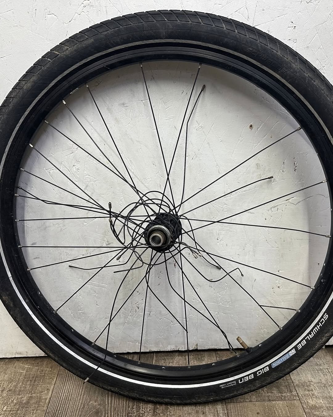 A bicycle wheel with damaged spokes in the service shop